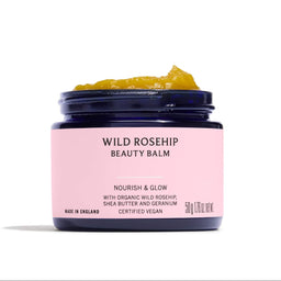 Jar of Wild Rosehip Beauty Balm with pink label on a white background