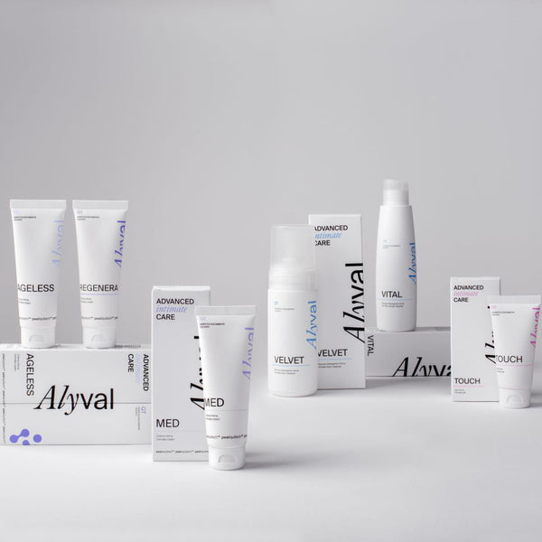 A collection of Aivval skincare products, including tubes, boxes, and bottles, arranged on a light gray studio background. The products are primarily white with black and blue/purple text and accents.