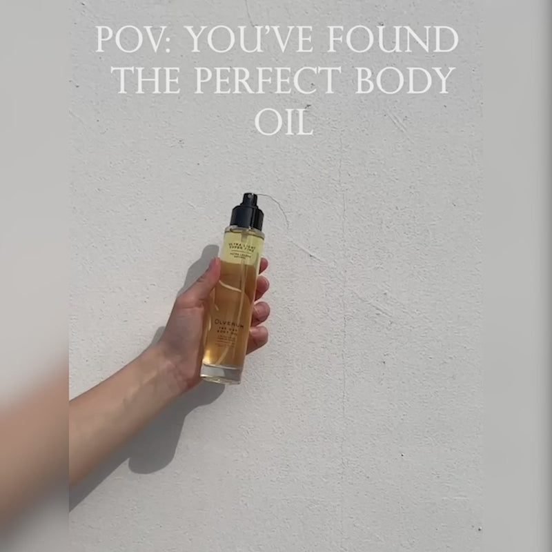 a women holding a bottle of Olverum The Dry Body Oil introduction video