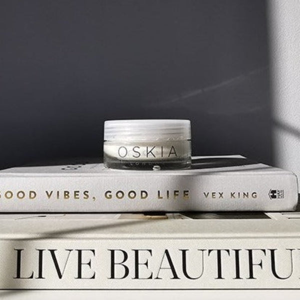OSKIA Bedtime Beauty Boost on top of two books