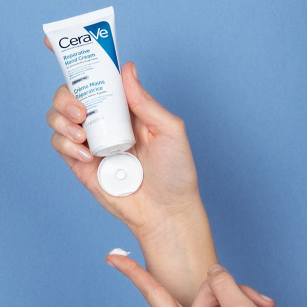 Model applying CeraVe Reparative Hand Cream
