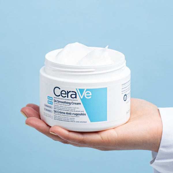 Model holding CeraVe SA Smoothing Cream 340ml with no lid showing its contents