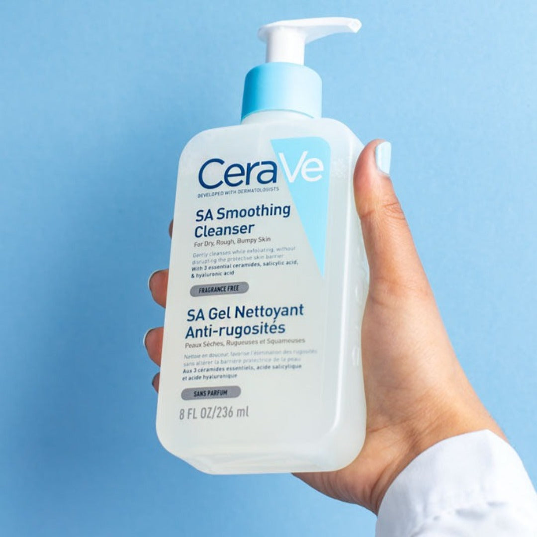 Model holding CeraVe SA Smoothing Cleanser 236ml bottle