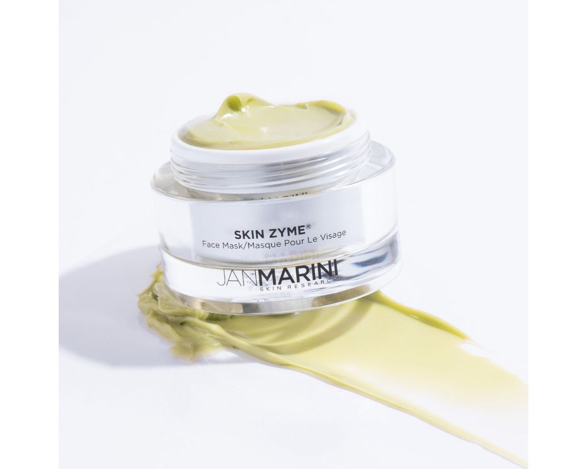 A jar of Jan Marini Skin Zyme Papaya Mask placed on top of a smear 