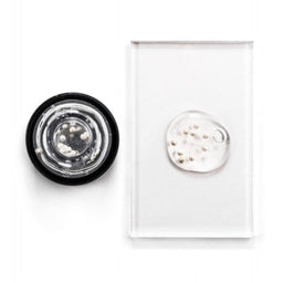 Avant Skincare Sublime Peony & White Caviar Illuminating Pearls Serum poured onto a slate