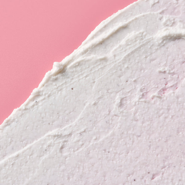 Close-up of a textured white surface with a pink background