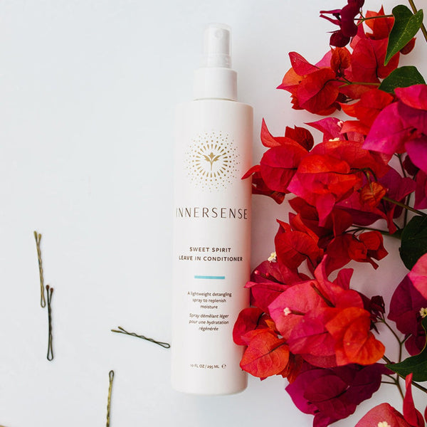 Innersense Sweet Spirit Leave-In Conditioner bottle surrounded by flowers