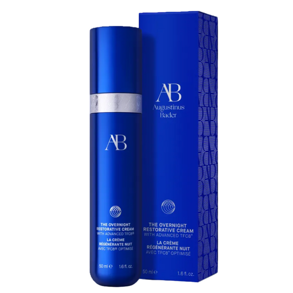 Augustinus Bader The Overnight Restorative Cream 50ml bottle in metallic blue with a silver band, standing next to its matching blue packaging box on a white background.
