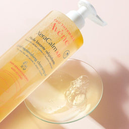 Avène XeraCalm A.D. Lipid-Replenishing Cleansing Oil for Dry, Itchy Skin poured onto a glass counter