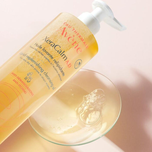 Avène XeraCalm A.D. Lipid-Replenishing Cleansing Oil for Dry, Itchy Skin poured onto a glass counter