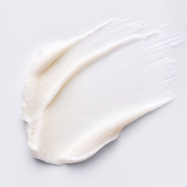 White cream or lotion swatch on a light gray background