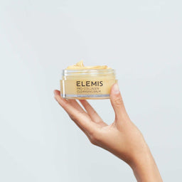 Elemis Pro-Collagen Cleansing Balm held in the palm of a hand