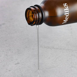 a bottle of Medik8 Try Me C-Tetra Luxe being poured out