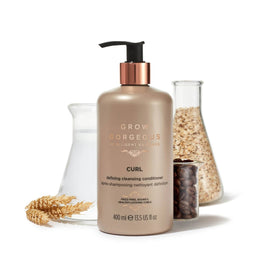 Grow Gorgeous Curl Defining Cleansing Conditioner in front of a range of test tubes