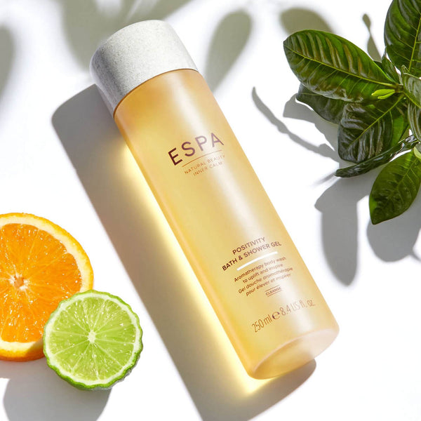 ESPA Positivity Bath & Shower Gel surrounded by its natural ingredients 