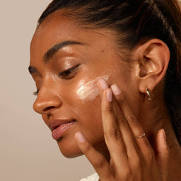 a women applying moisturiser to her face