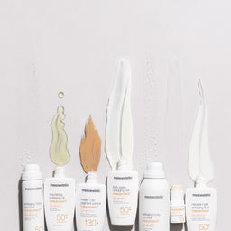 Range of mesoestetic products with their contents poured out