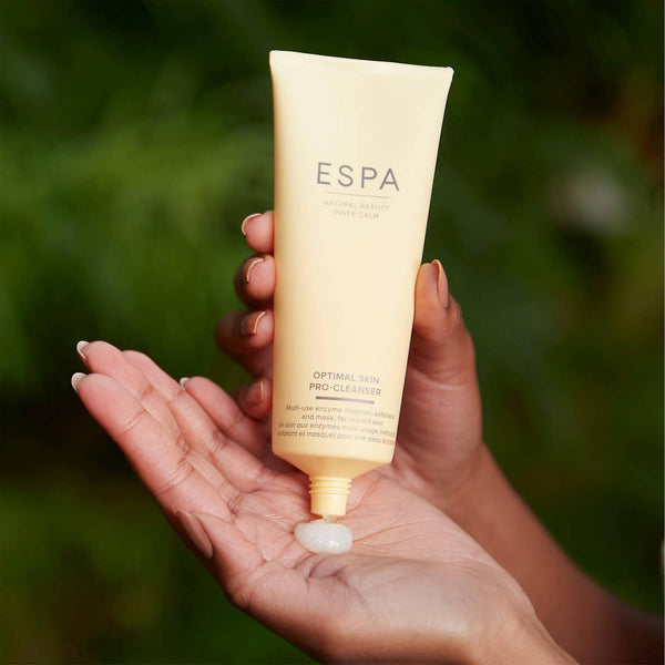 ESPA Optimal Skin ProCleanser being poured into the palm of a hand