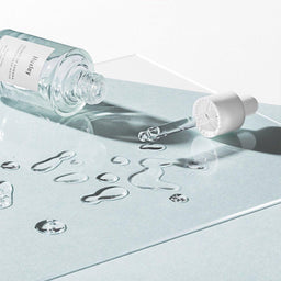 Huxley Essence; Grab Water bottle tipped over its its pipette pouring out