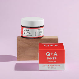 Q+A 5HTP Face & Neck Cream on a wooden block