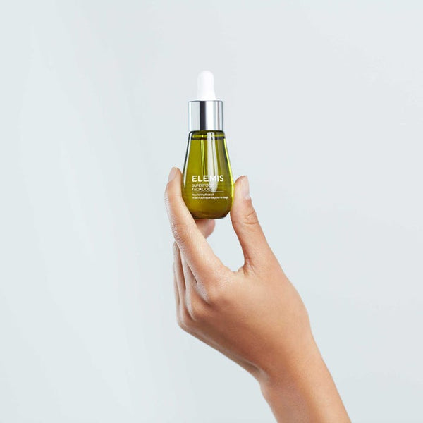 Elemis Superfood Facial Oil held in the palm of a hand