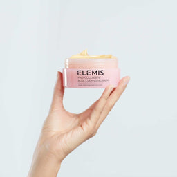Elemis Pro Collagen Rose Cleansing Balm held in the palm of a hand