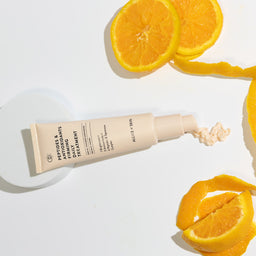 Allies of Skin Peptides & Antioxidants Firming Daily Treatment surrounded by oranges