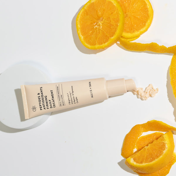 Allies of Skin Peptides & Antioxidants Firming Daily Treatment surrounded by oranges