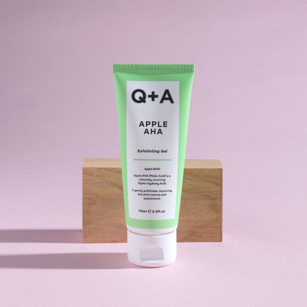 Q+A Apple AHA Exfoliating Gel in front of a wooden block