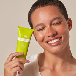 model holding Image Skincare BIOME+ Cleansing Comfort Balm close tot their face