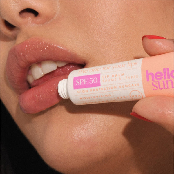 a closeup of a women applying Hello Sunday The One For Your Lips SPF50 Lip Balm to her lips