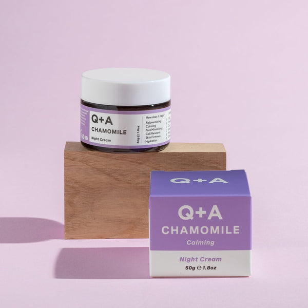 Q+A Chamomile Night Cream tub sat on a wooden block