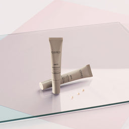 Two Codex Labs Antu Brightening Eye Cream tubes on top of a glass sheet