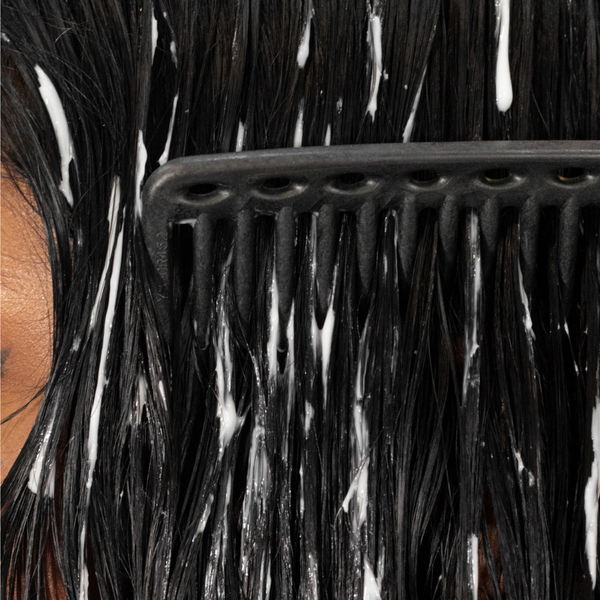 closeup of a comb brushing through hair