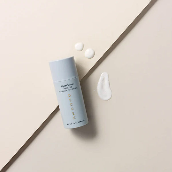 Decree AM Essentials with three drops of serum next to the bottle