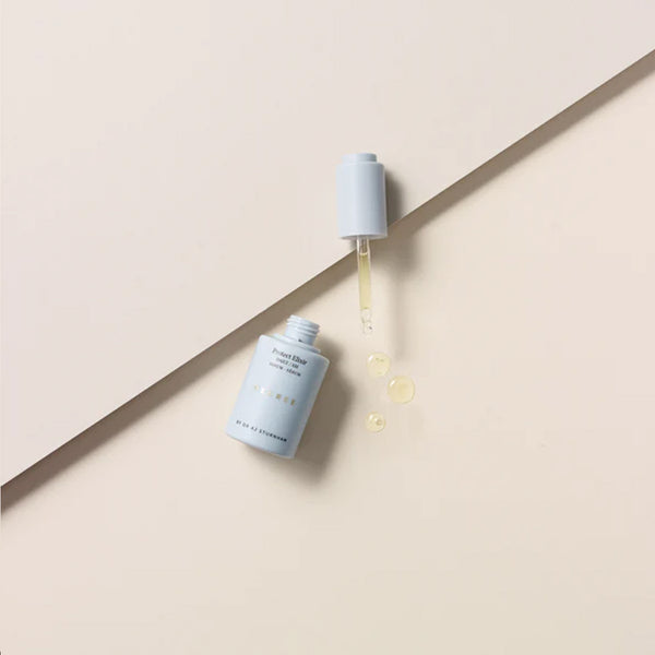 Decree AM Essentials with three drops of serum next to the bottle