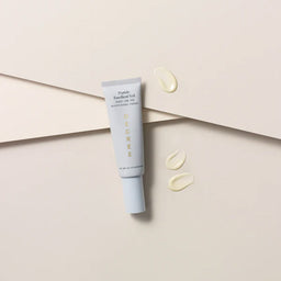 Decree AM Essentials with three drops of cream next to the tube