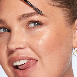 A closeup of a women applying HD Brows Brow Colourfix