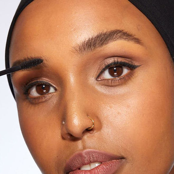 A closeup of a women applying HD Brows Brow Colourfix