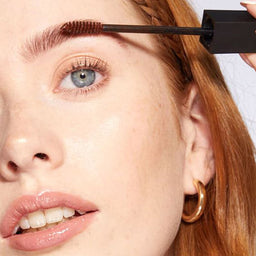 A closeup of a women applying HD Brows Brow Colourfix