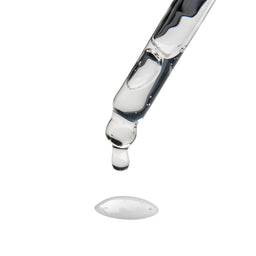 a pipette dripping serum onto a white surface