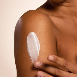 Nursem Caring Body Cream texture applied to a womens shoulder