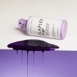 Olaplex No.4P Blonde Enhancer Toning Shampoo bottle tipped over and its contents poured over a purple edge