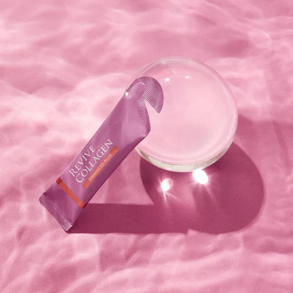 a single sachet of Revive Collagen Enhanced next to a clouded orb