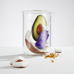 Nip+Fab Retinol Fix Booster Extreme with a half of coconut and avocado in a glass jar
