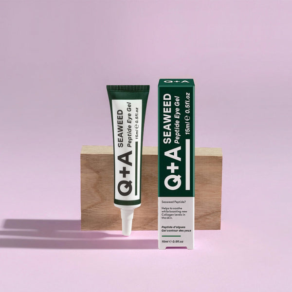 Q+A Seaweed Peptide Eye Gel in front of a wooden block