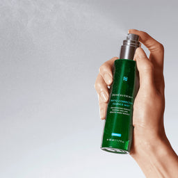 SkinCeuticals Phyto Corrective Essence Mist for Sensitive Skin bottle being sprayed into the air