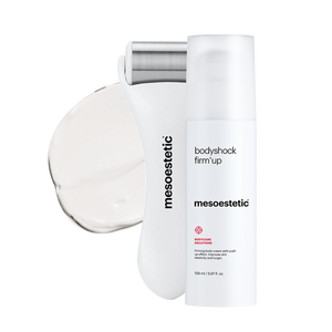 A container of mesoestetic Bodyshock Firm’ Up & its Roller behind it, with the cream contents behind that#