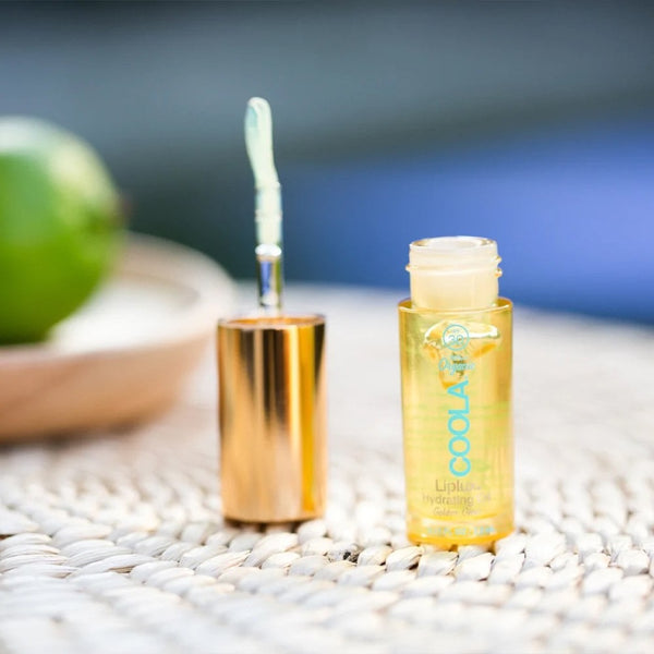 COOLA Classic Liplux Oil bottle on a table top