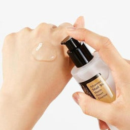 COSRX Advanced Snail 96 Mucin Power Essence being poured onto a models hand